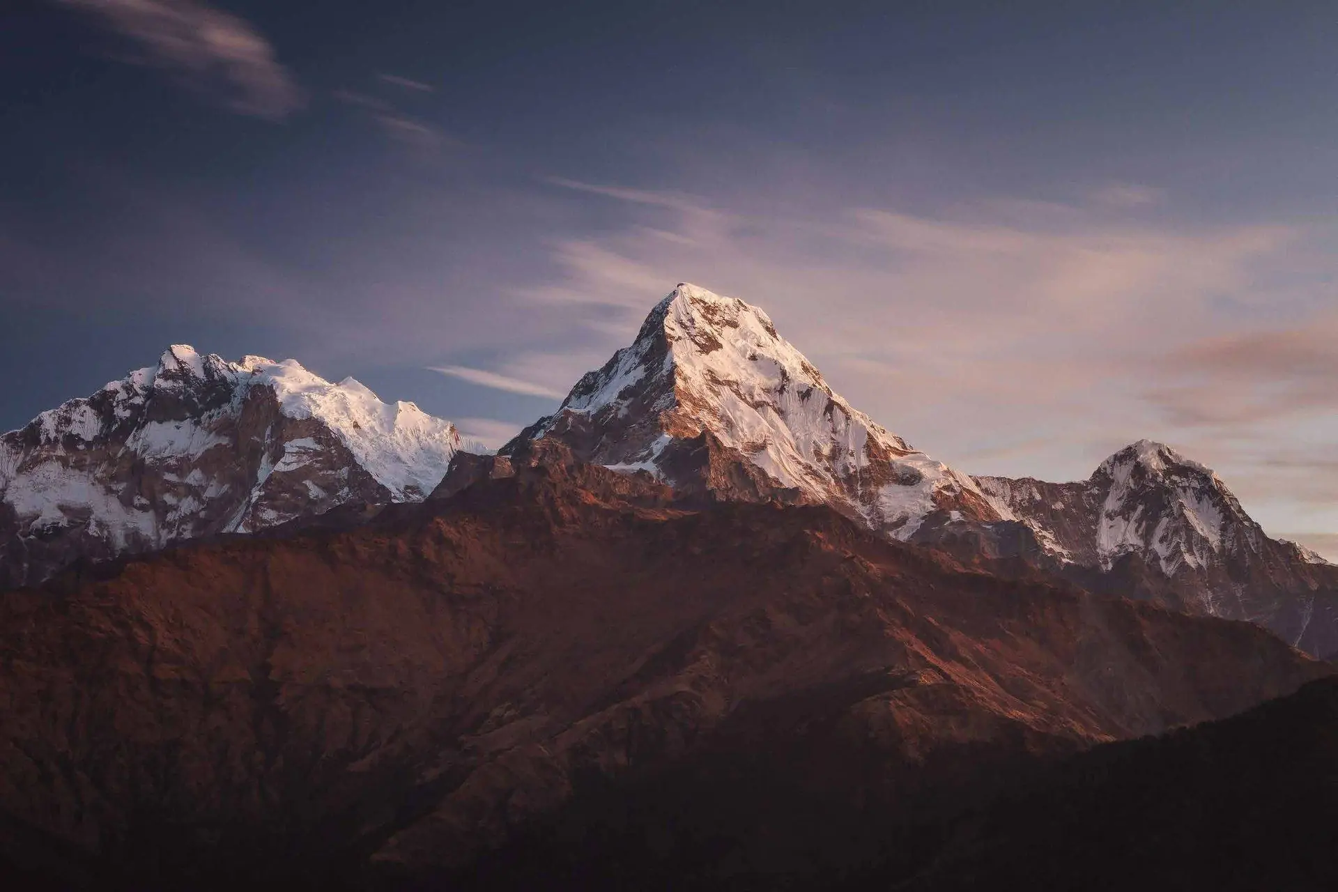 Snow-capped mountain peak at dusk